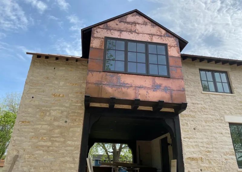 Copper metal panel facade on a stone building for Roof Repair in Lampasas