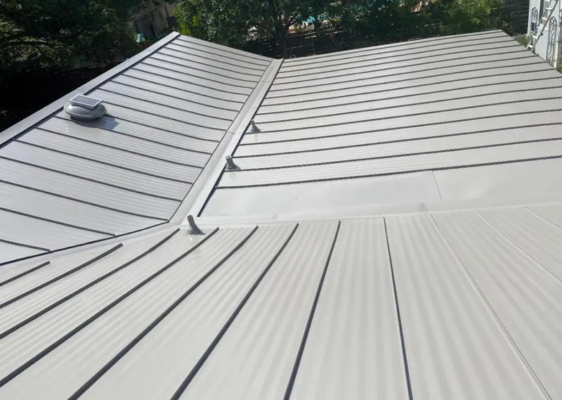 Solar attic fan installed on a metal roof for Roof Ventilation in Lampasas
